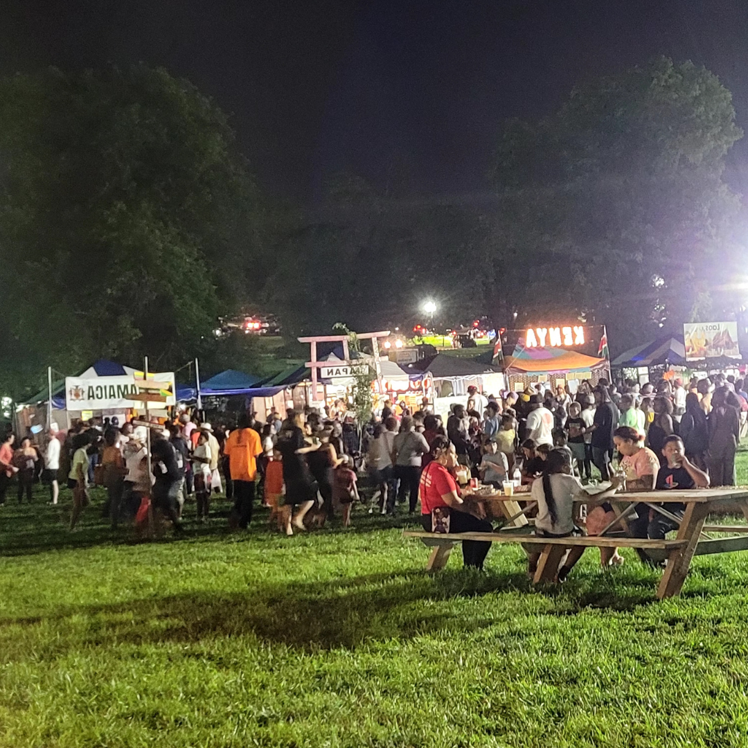 photo of booths such as Kenya, Japan, and Jamaica at the 2023 Ethnic Enrichment Festival at night