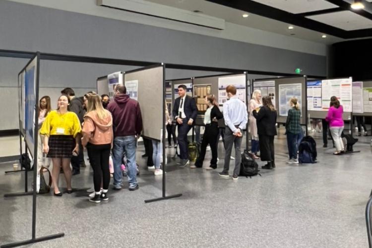 Students show their displays to attendees