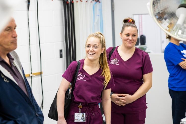 A dental hygiene student smiles at the Kansas City Zoo and Aquarium veterinarian