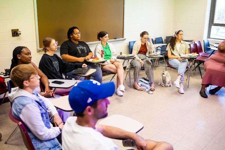 Kayla sits with classmates in a UMKC classroom