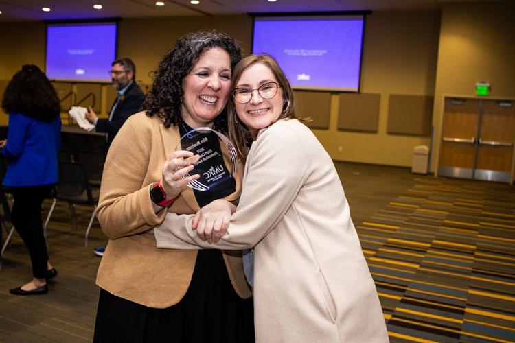 Two people hugging at 2024 Staff Awards ceremony