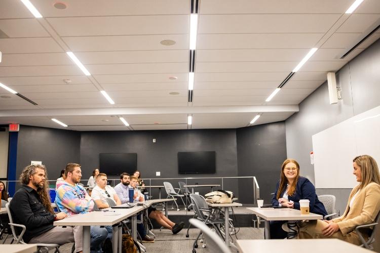 Kylie DeWees and Annmarie Orlando sit at a table facing a classroom of UMKC law students